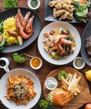 Ett bord med olika restaurangrätter fotograferat från ovan.