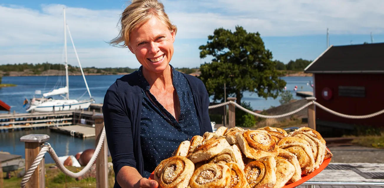 Kvinna bjuder på bullar på Rödhamn